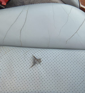 Hole in Leather Car Seat Before